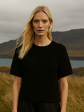 Wool sweater with short raglan sleeves, round neck, and ribbed cuffs, featuring a relaxed fit.